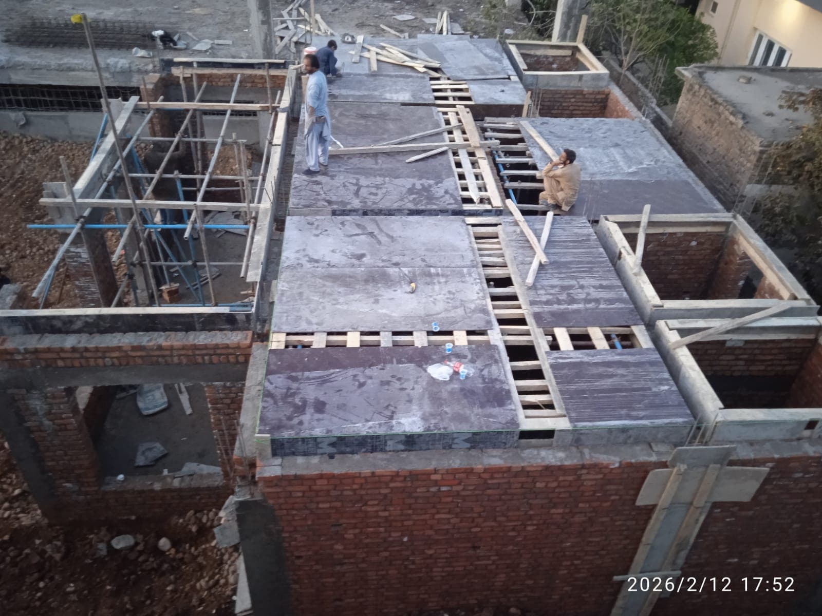 Reinforced concrete roof slab with shuttering during construction