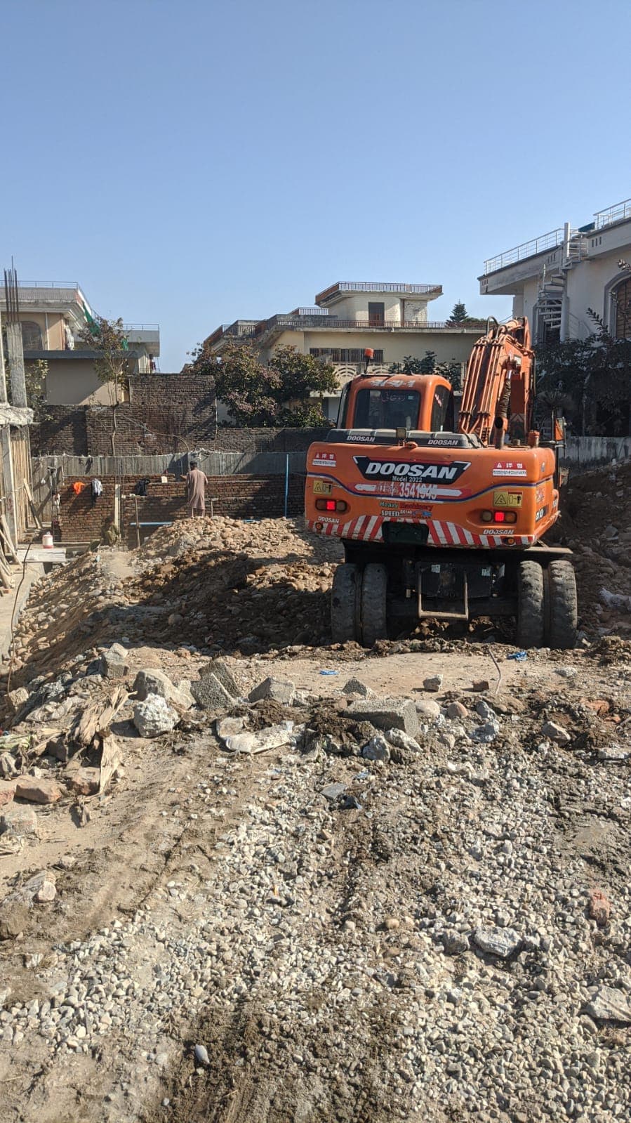 Excavator carrying out site earthwork and excavation