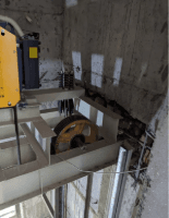 Lift traction machinery and sheave at the top of the elevator shaft