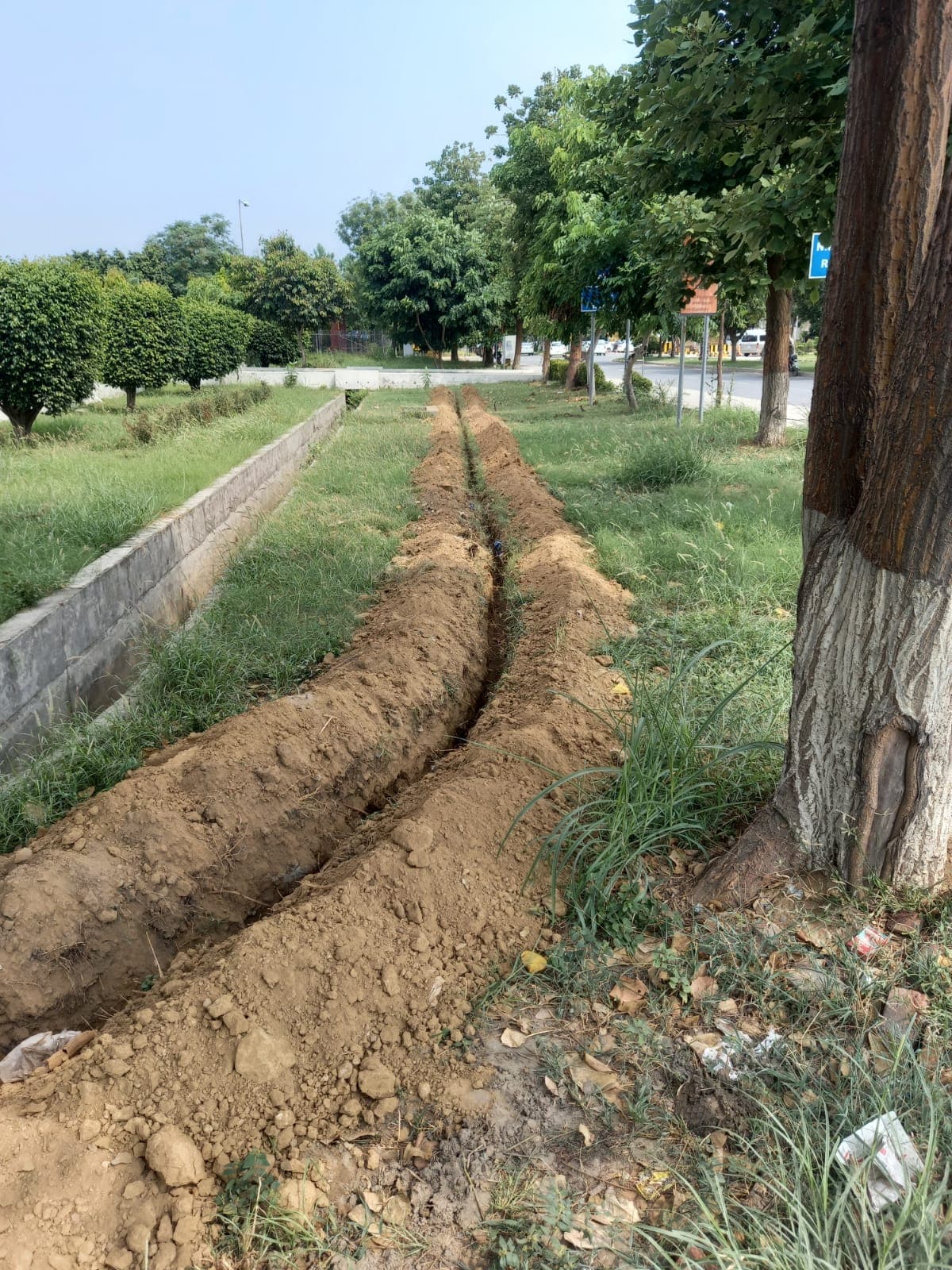 Optical fiber cable trench dug along a roadside
