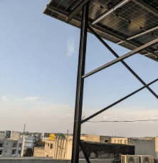 Solar panel installation over a city skyline