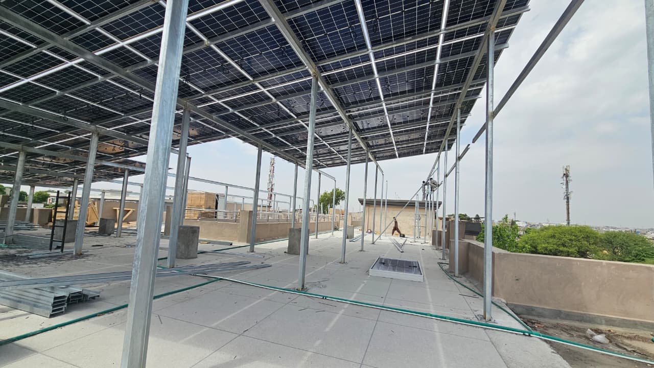 Solar panel canopy structure under installation on a rooftop