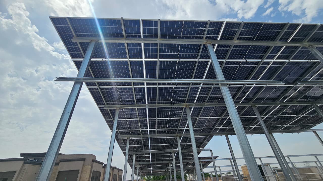 Elevated solar panel canopy against a clear sky