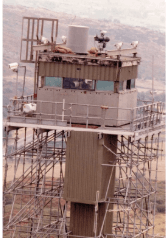 Close-up of watch tower observation cabin with mounted surveillance equipment