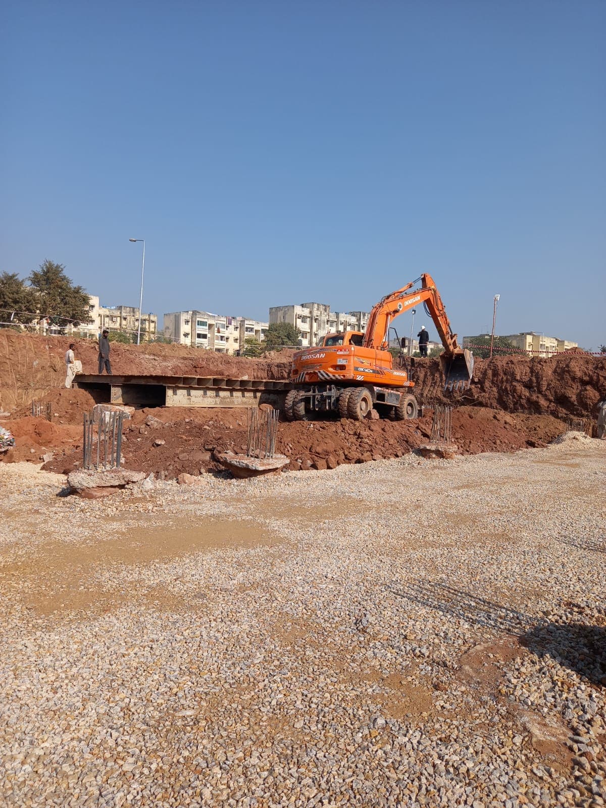 Excavator carrying out foundation earthworks for an infrastructure project