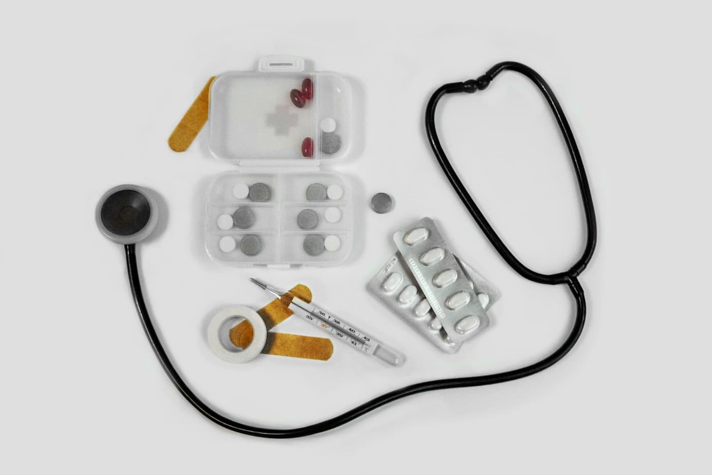 First-aid medical kit with stethoscope, thermometer, dressings and medication