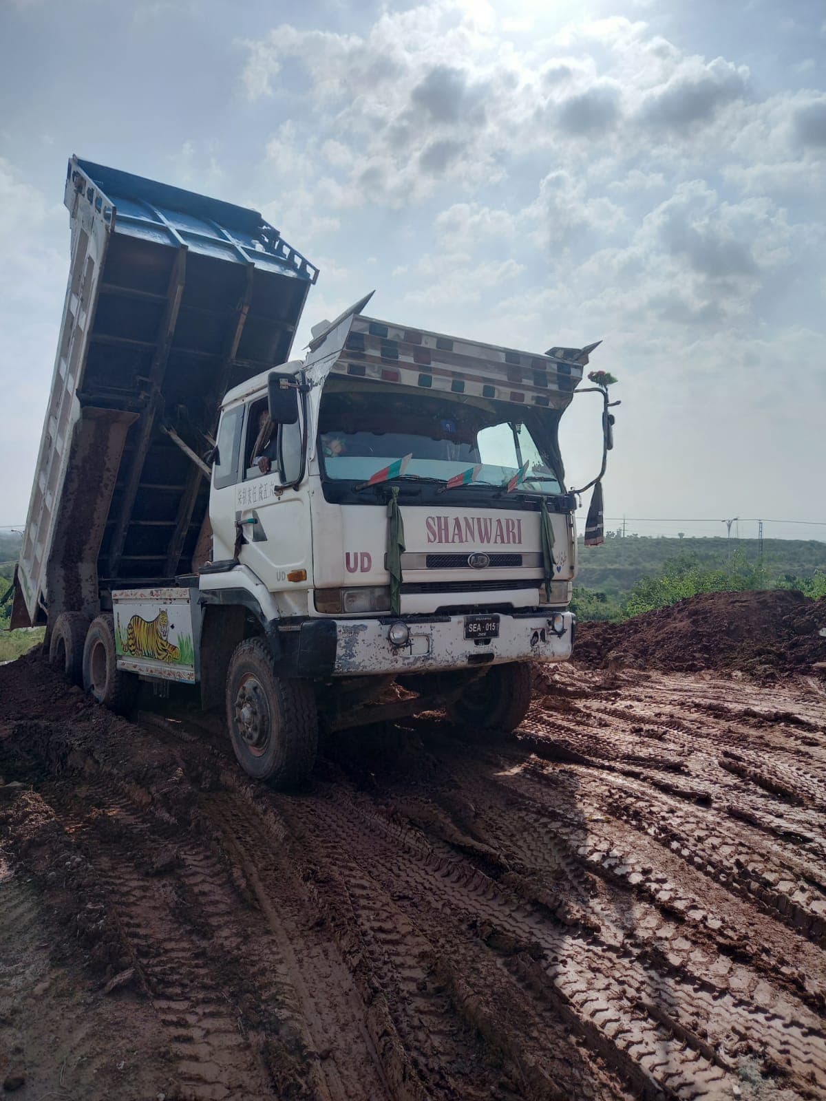 Heavy-duty dump truck delivering material to a project site
